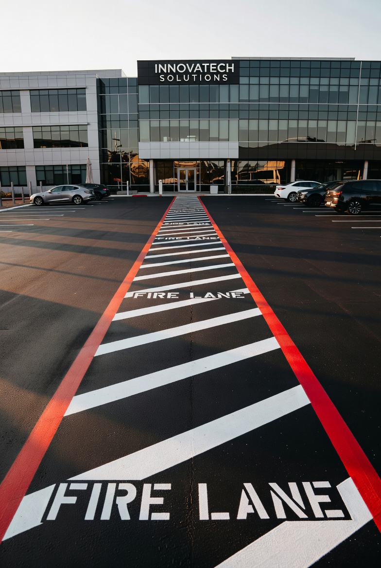 Red curb fire lane painting with NO PARKING stencils